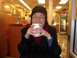 Brian sipping coffee at Dunkin Donuts