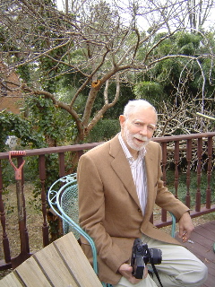 Uncle Paul smoking a cigarette on his back porch. Note bamboo in backyard.