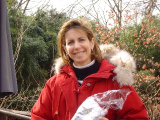Linda wearing a bright red coat.