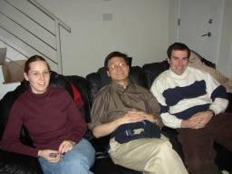 three people sitting on the couch